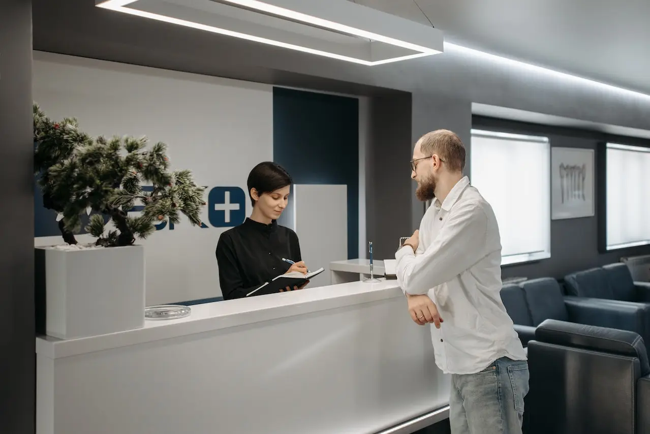 Man standing in the reception of a clinic